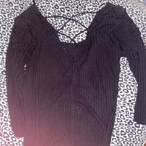 Black long sleeve, with criss cross in the back.